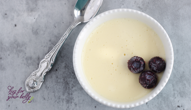 custard in dish with blueberries and spoon 