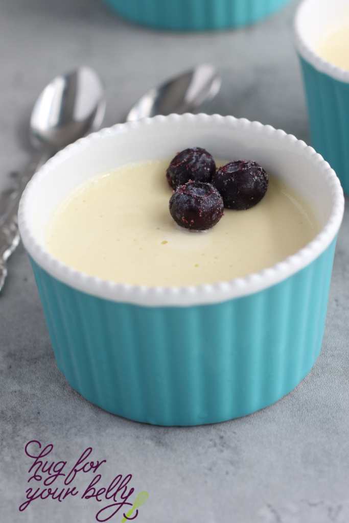 vanilla custard in dish with blueberries with spoon 