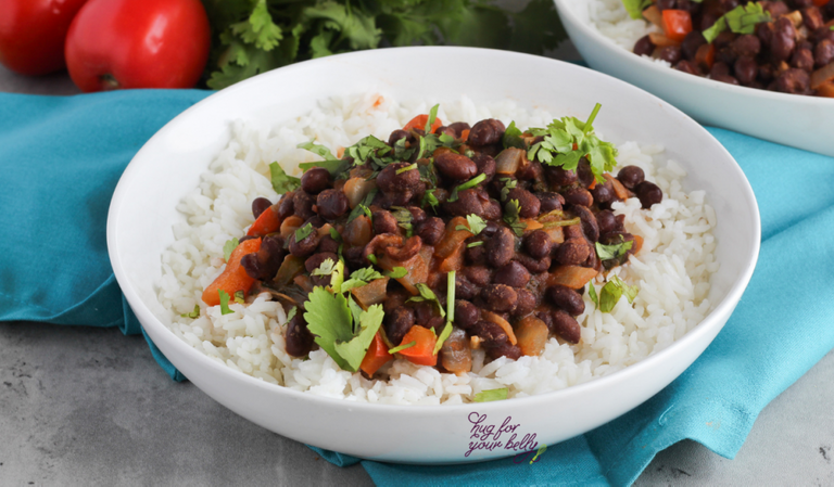 cuban black beans over white rice in a white bowl