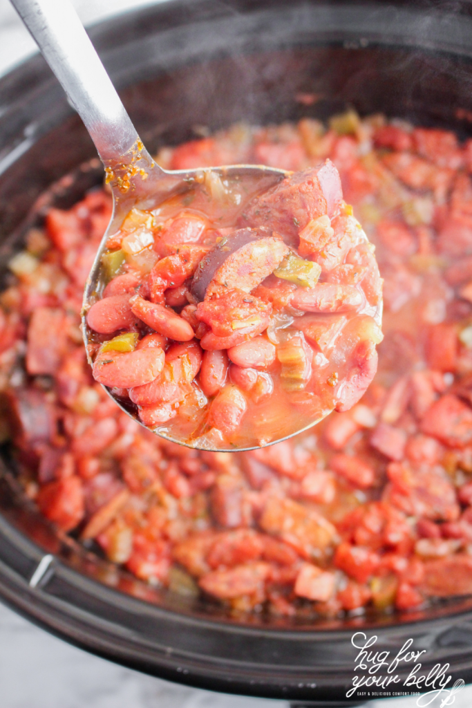 red beans on a ladel over a crockpot
