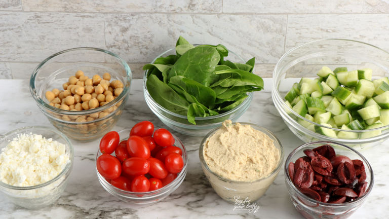 ingredients for hummus bowl in clear bowls