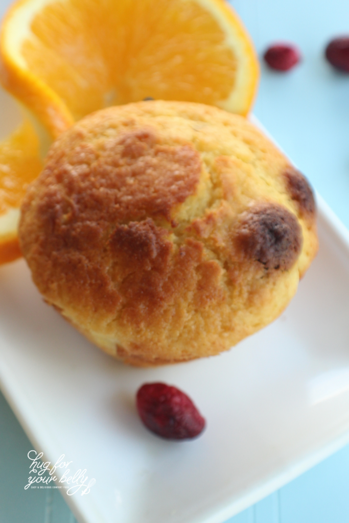 cranberry orange muffin on white plate