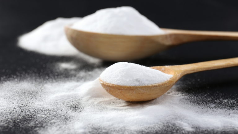 baking soda and baking powder on wooden spoons