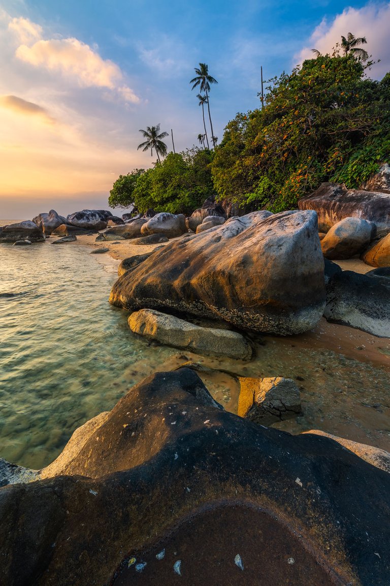 Rocks at Beach on Tioman Island glowing in warm evening Light