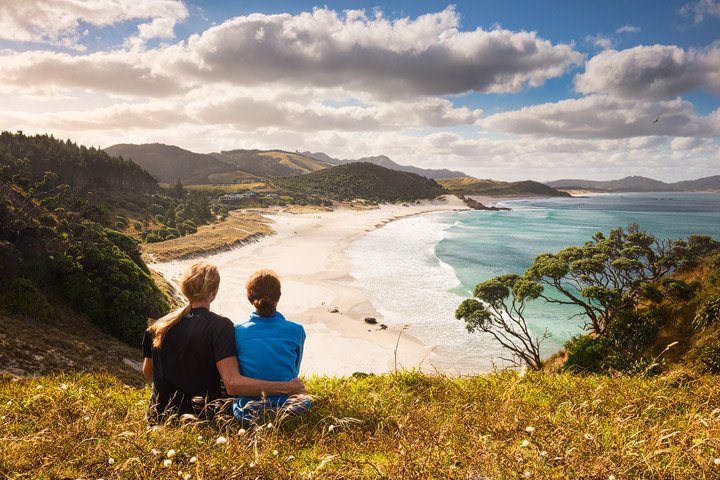 A joung couple overlooking Ocean Beach in New Zealand