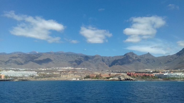 You can just about make out the paragliders against the mountainous backdrop… perhaps your next activity!