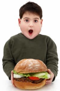 picture of hungry boy with burger