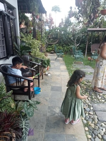 "The Cousins’ Joyful Bonding: Blowing Bubbles and Making Memories in Grandparents' Garden."