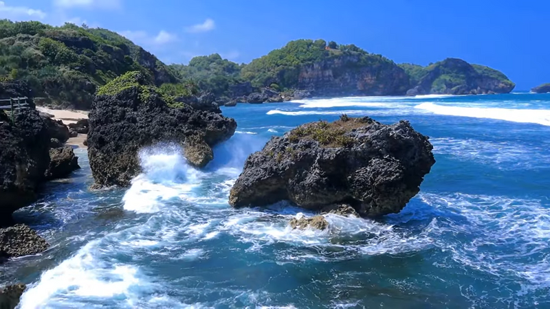 Rock with holes while exploring Watu Bolong beach.