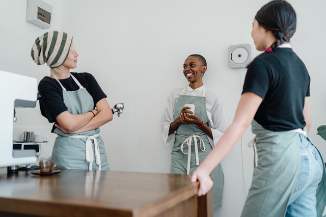 photo-of-three-women-standing-while-talking-to-each-other-4349933.jpg