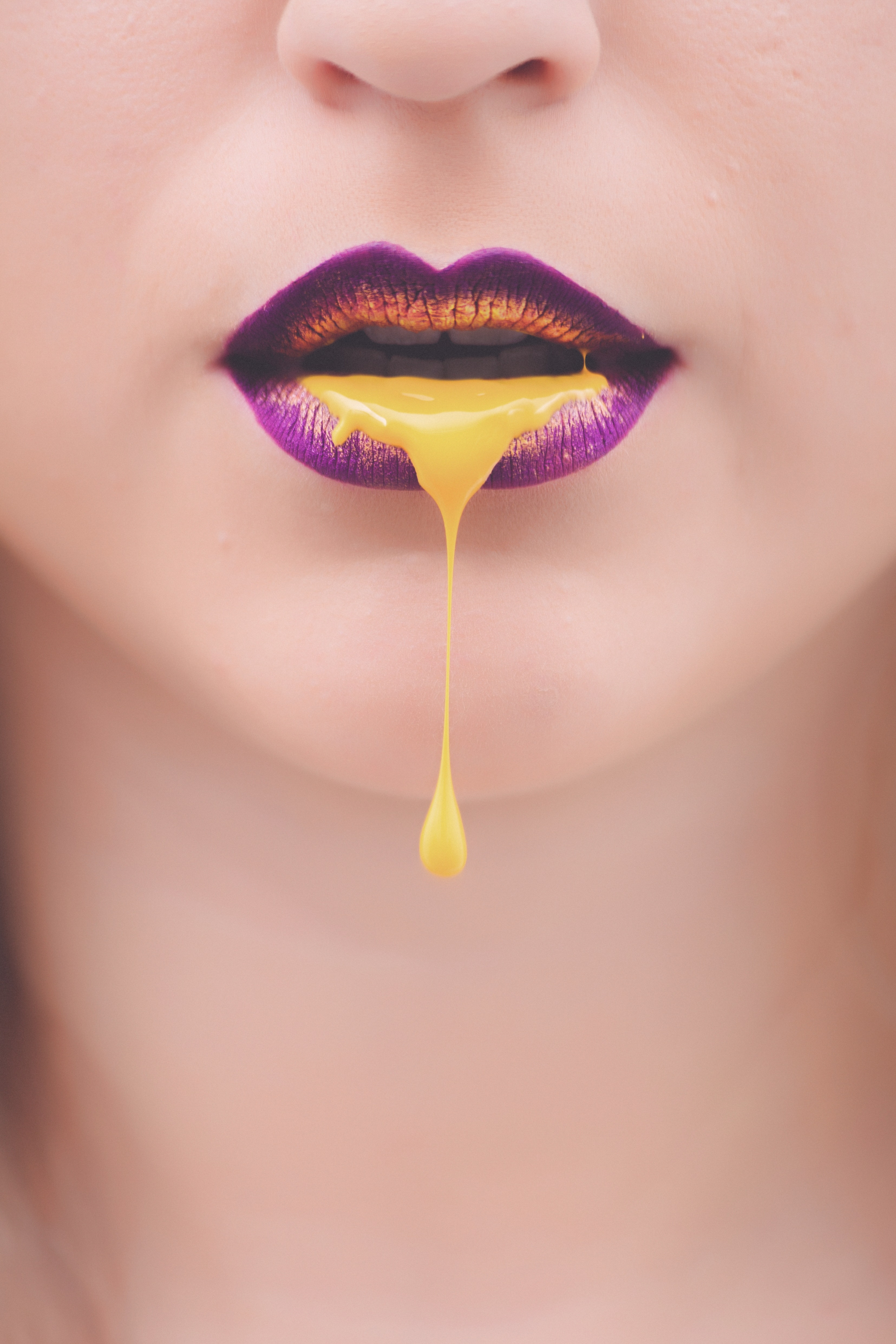 women-s-purple-and-yellow-lips-with-yellow-liquid-922470.jpg