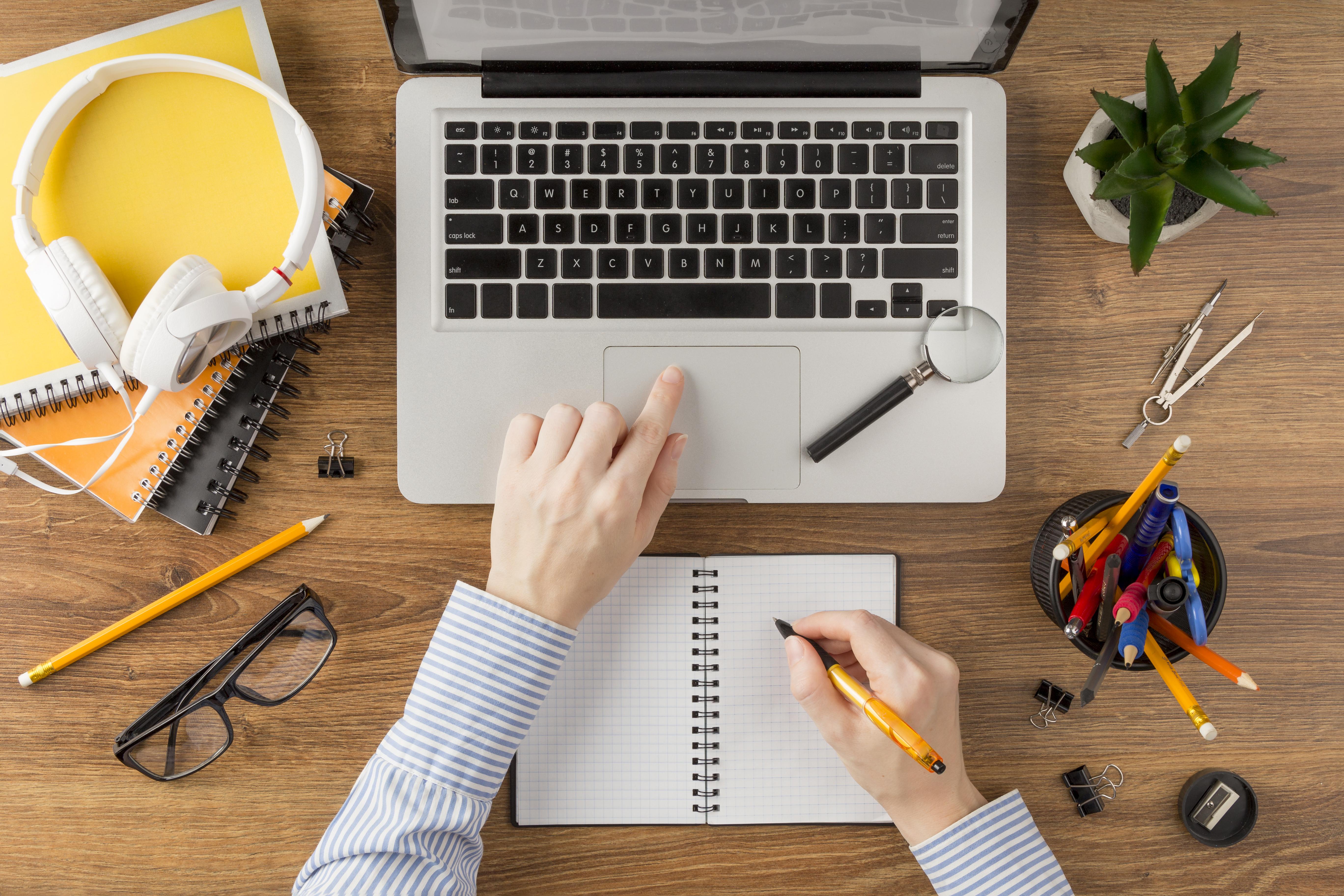 student-writing-notebook-desk.jpg