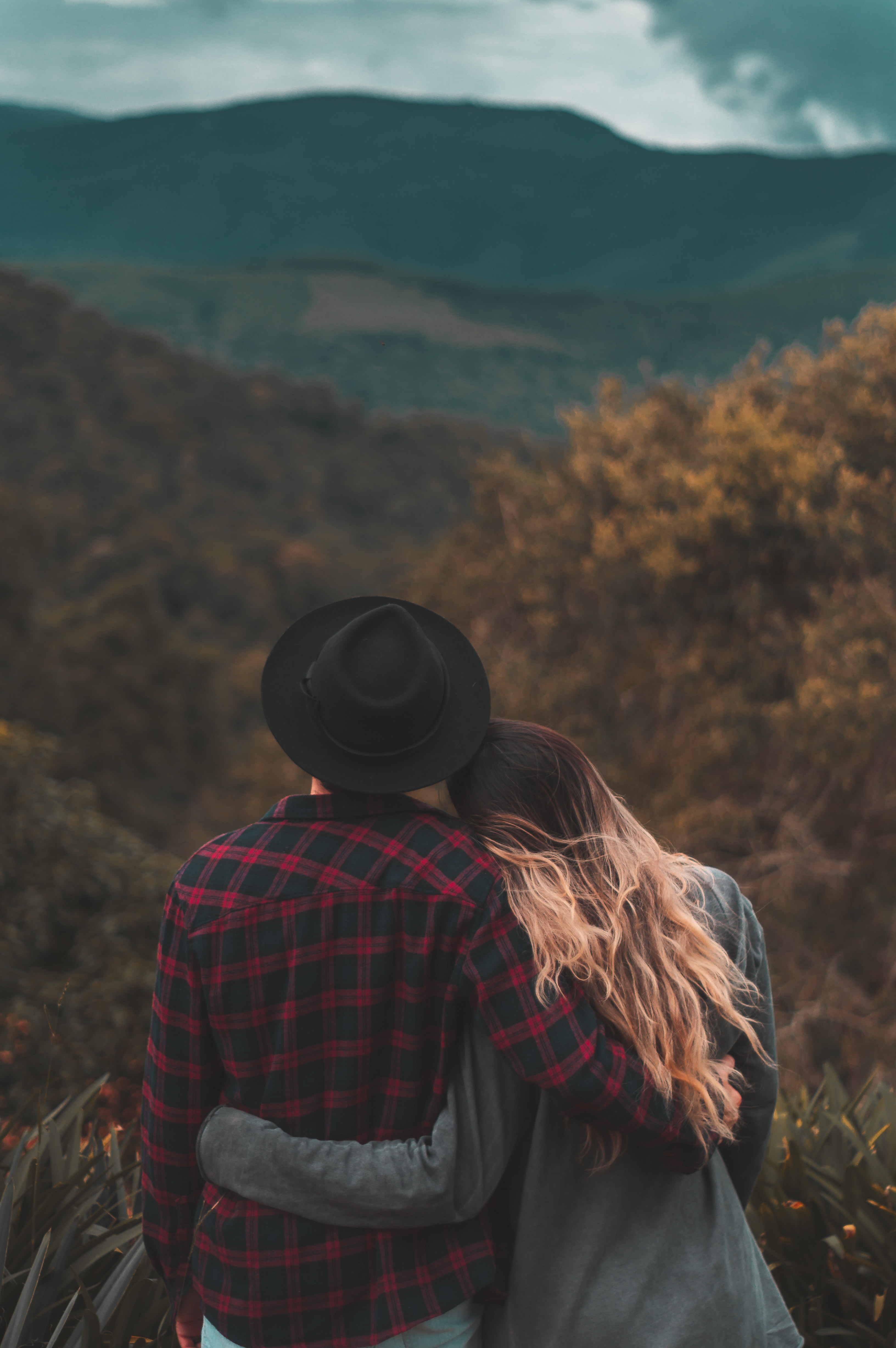 couple-standing-on-top-of-hill-1995718.jpg