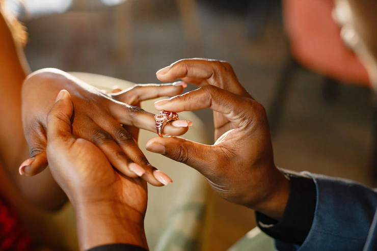 cropped-photo-hands-black-man-wearing-engagement-ring-his-girlfriend-s-finger_1157-52016.webp