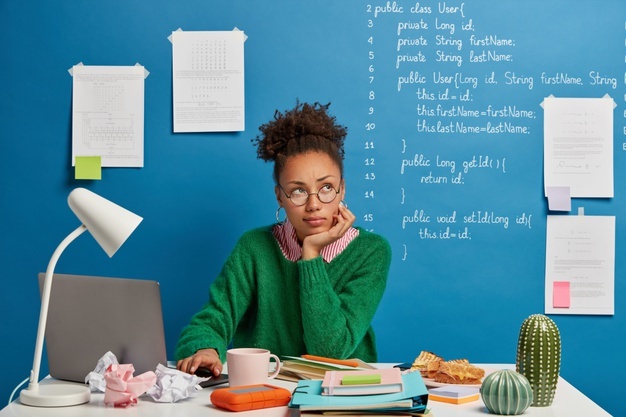 ethnicity-woman-poses-worktable-looks-away-being-distracted-from-work-ponders-about-something-while-works-modern-laptop_273609-34560.jpg