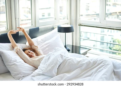 woman-stretching-bed-after-wake-260nw-292934828.webp