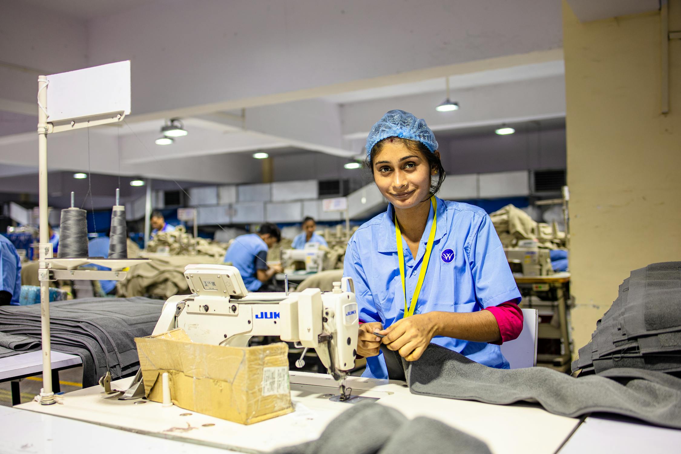 free-photo-of-textile-worker-operating-sewing-machine-in-factory.jpeg