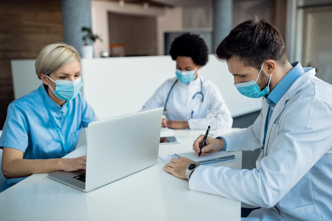 male-doctor-taking-notes-while-working-with-colleagues-medical-clinic_637285-11174.jpg