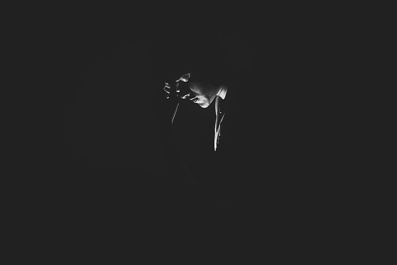 monochrome-photography-of-person-on-dark-room.jpg