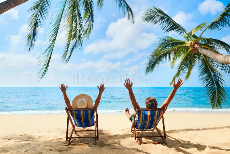 happy-couple-arms-up-relax-beach-enjoy-beautiful-sea-tropical-island-happy-couple-arms-up-relax-150711662.jpg