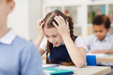 depositphotos_335496668-stock-photo-stresssed-schoolgirl-at-lesson.jpg