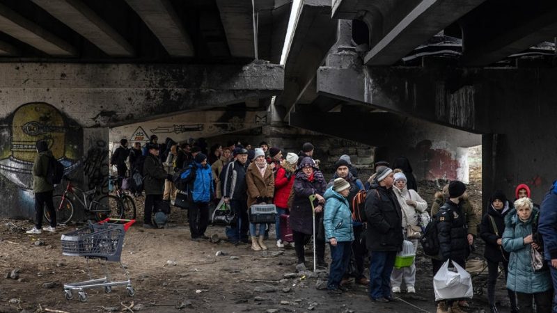 People-wait-inder-a-destroyed-bridge-in-Ukraine-800x450.jpg