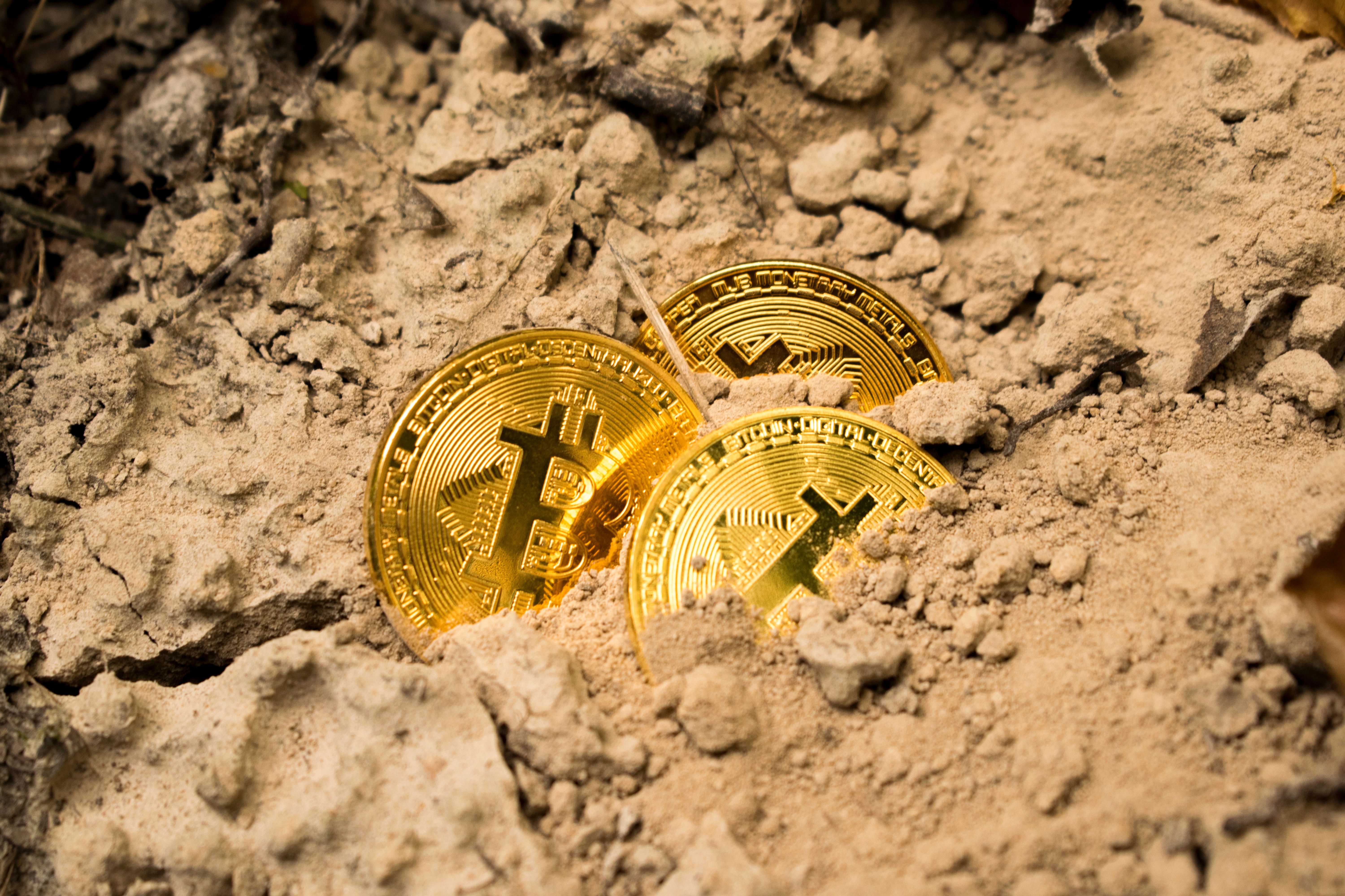 bitcoins in sand unsplash.jpg