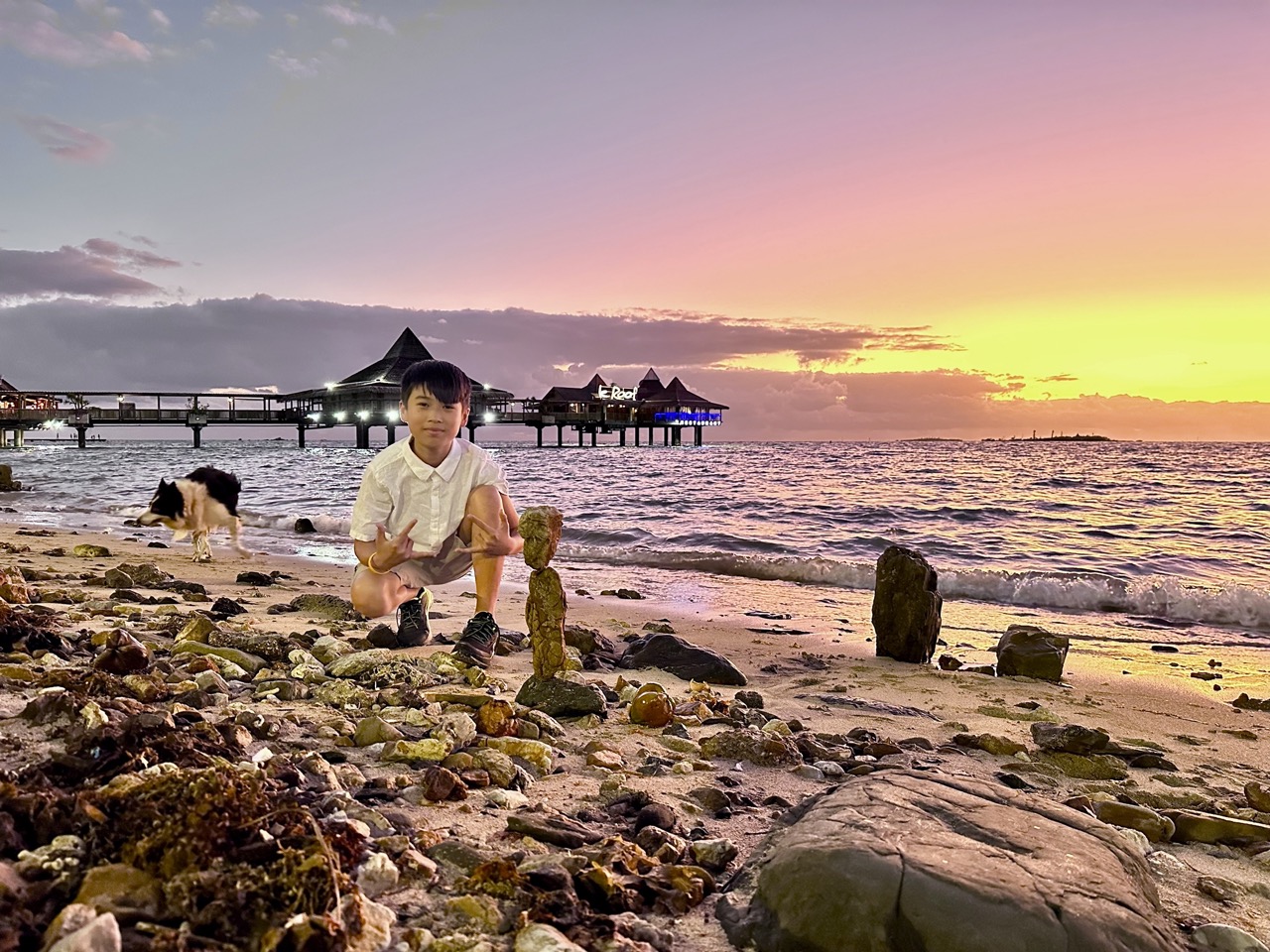 San doing rock balancing in front of Le Roof, Noumea