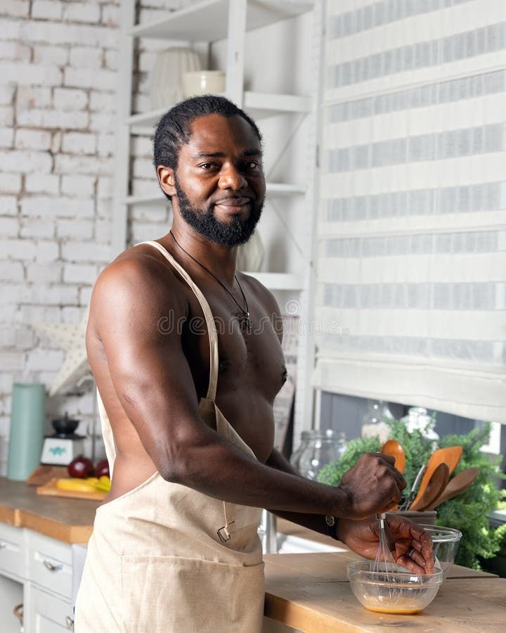 Black man cooking breakfast or lunch on kitchen at home_ African American man wearing an.jpeg