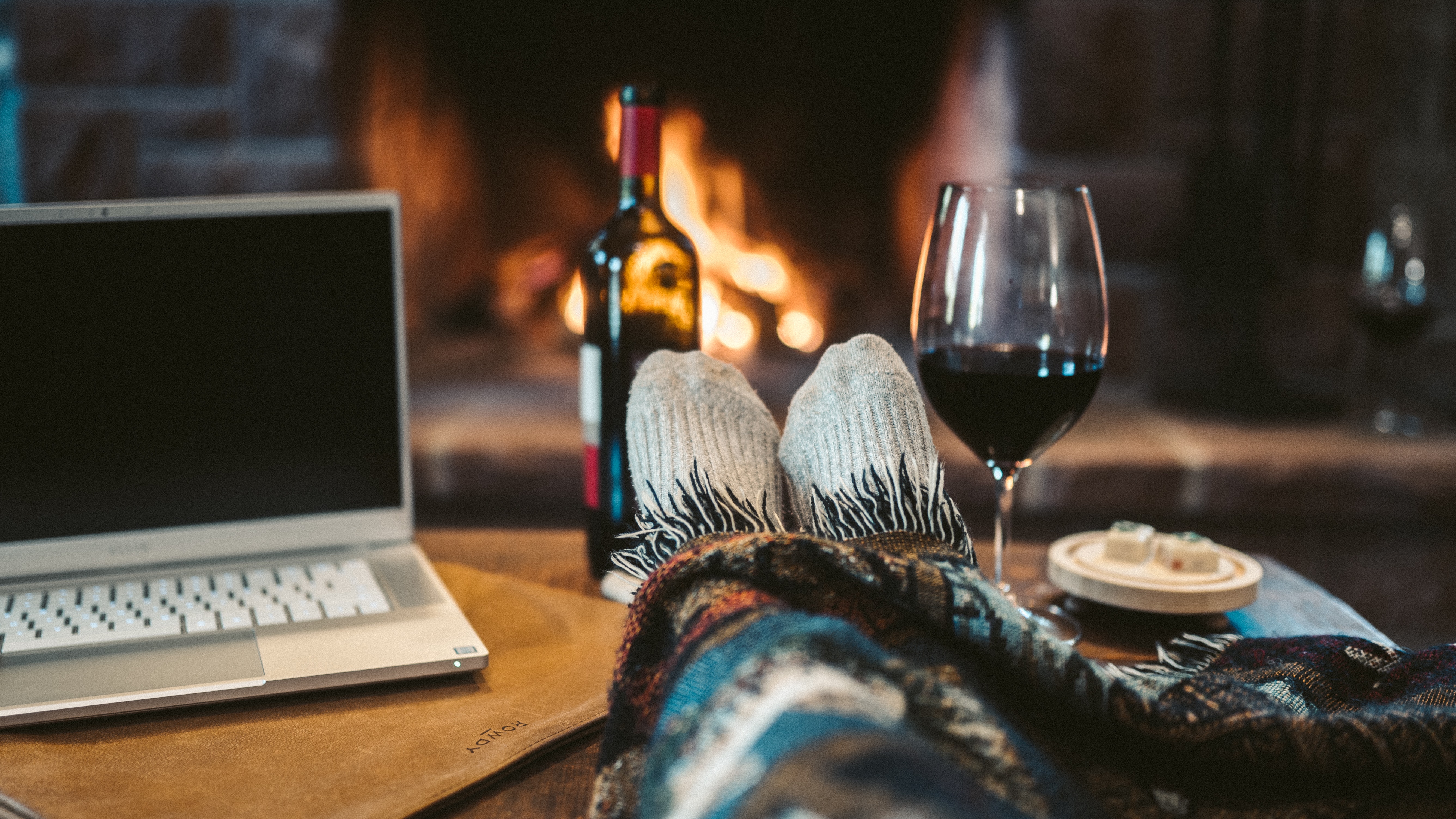 macbook-pro-beside-wine-glass-on-brown-wooden-table-4099298.jpg