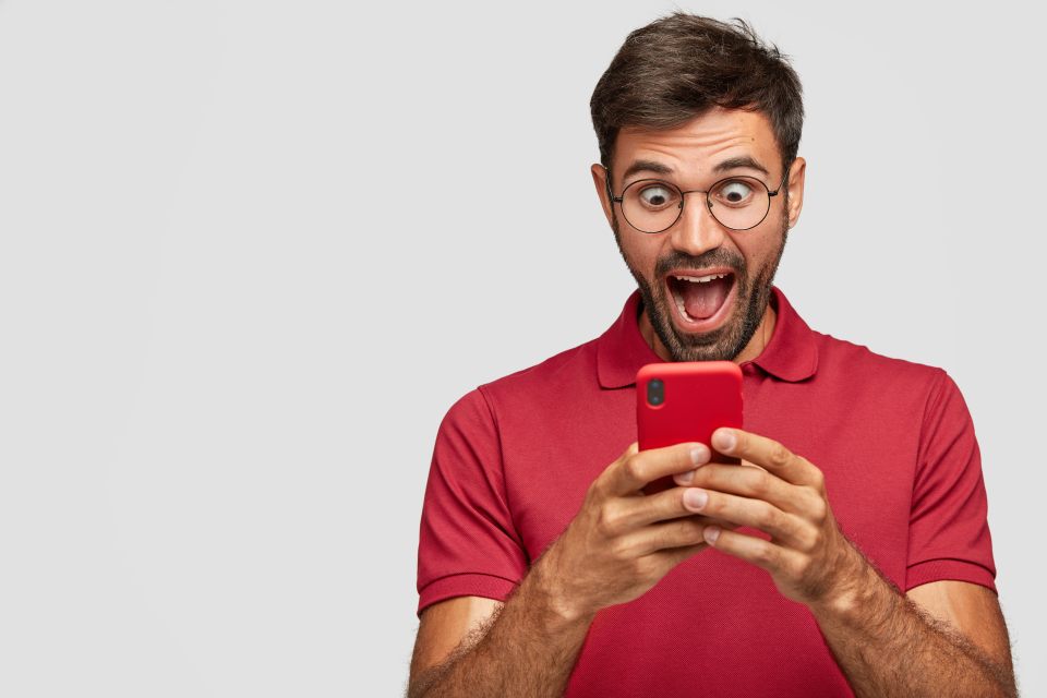 amazed-young-emotional-man-posing-against-white-wall.jpg