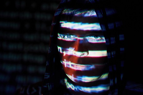 cyber-attack-with-unrecognizable-hooded-hacker-using-virtual-reality-digital-glitch-effect (1).jpg