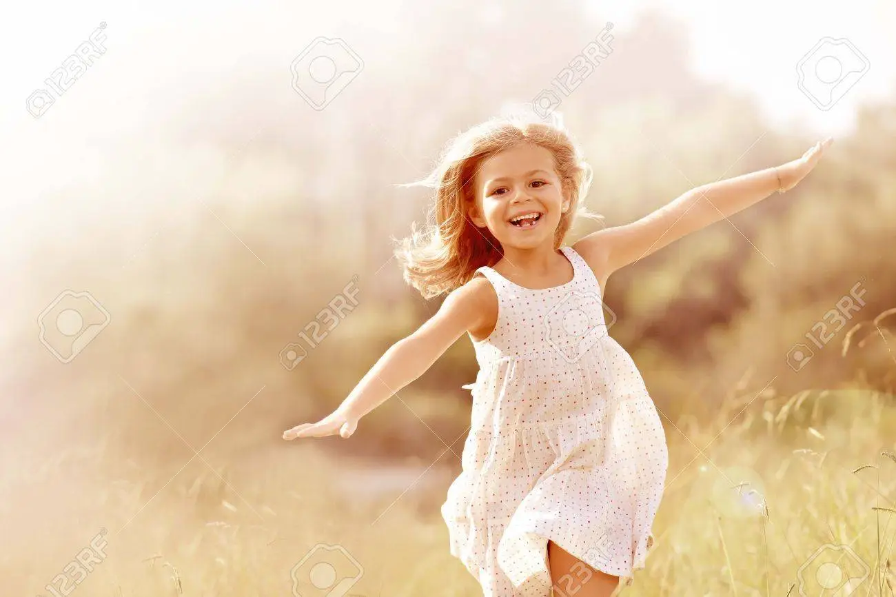 65781601-little-girl-running-in-country-field-in-summer.webp