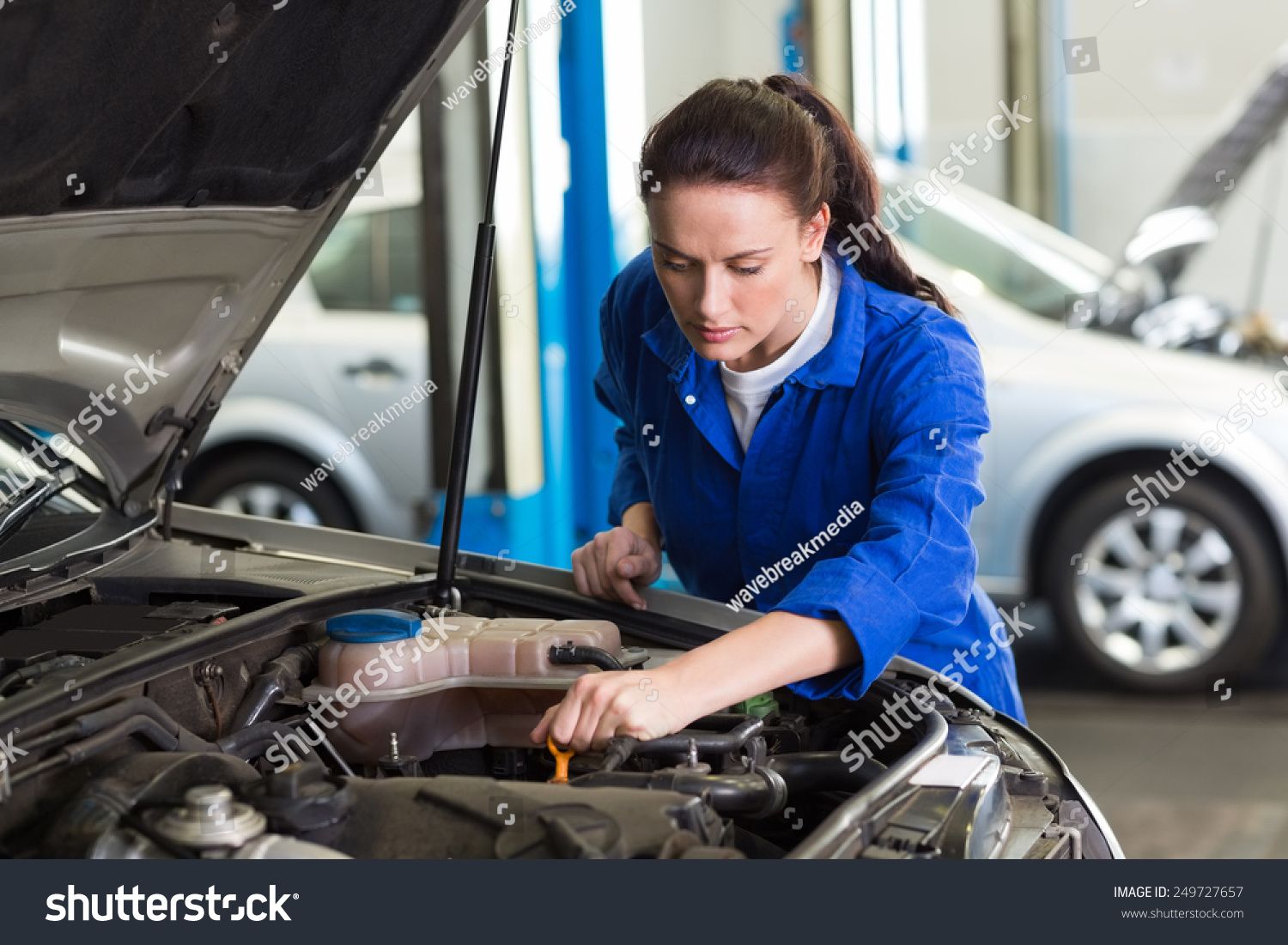 stock-photo-mechanic-working-under-the-hood-at-the-repair-garage-249727657.jpg