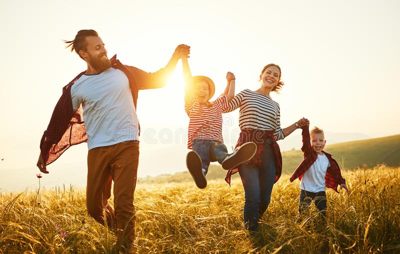 happy-family-mother-father-children-son-daughter-sunset-nature-150794881.jpg