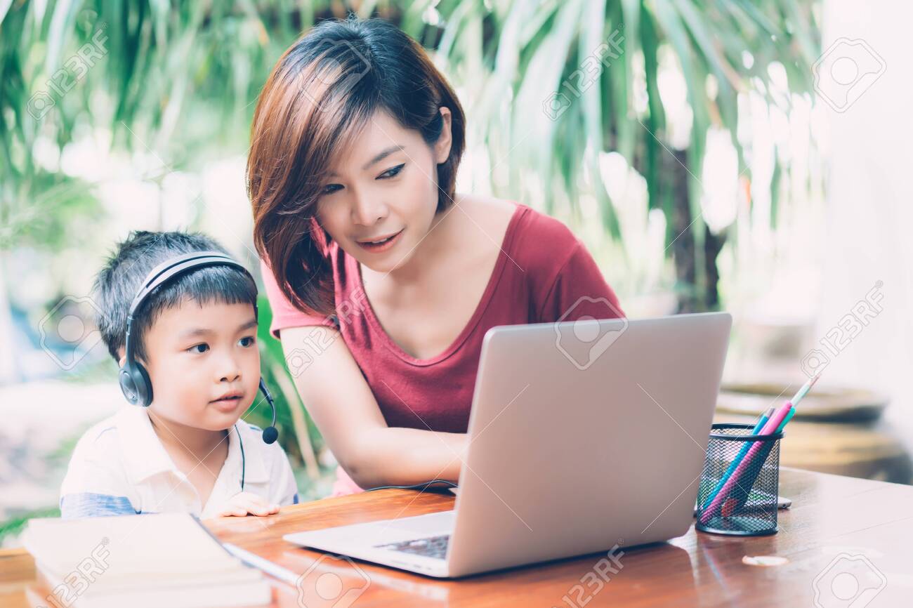 149887517-young-asian-mother-and-son-using-laptop-computer-for-study-and-learning-together-at-home-boy-wearing.jpg