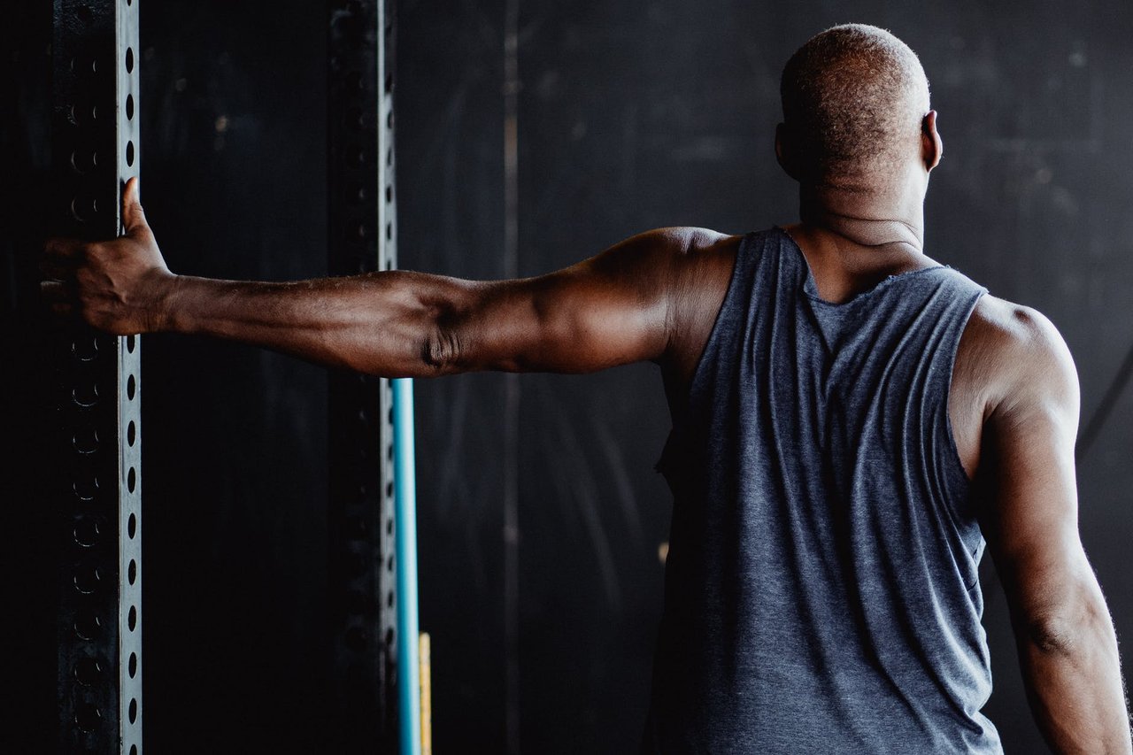 shallow focus photo of man stretching