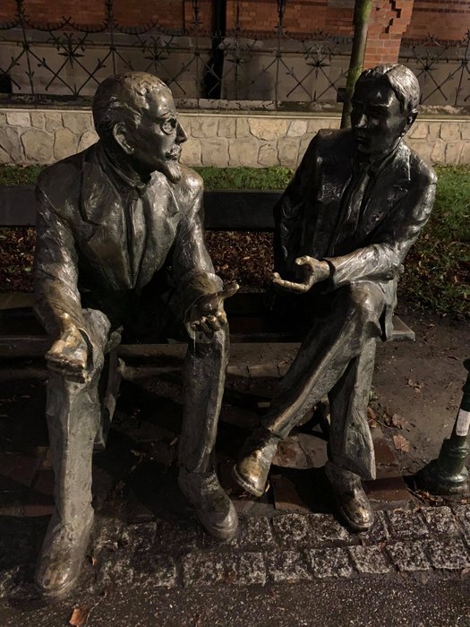 Two students on a bench in Planty park, Kraków