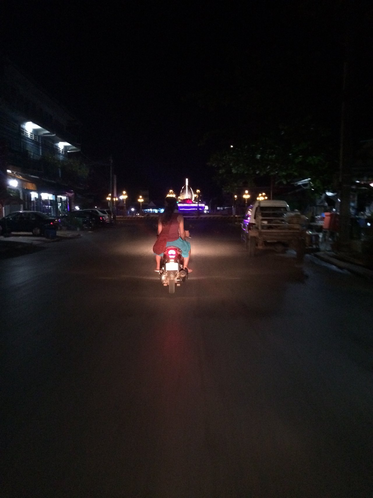Off in the distance the shine of the Durian roundabout at night