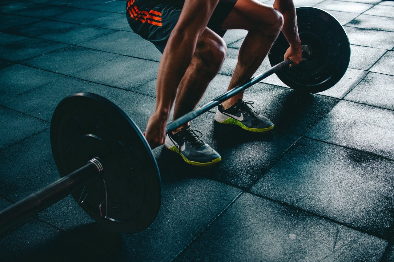 person holding barbell