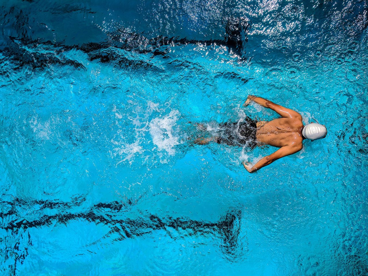 person swimming on body of water